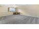 Spacious carpeted basement with a large window and desk; ready for customization at 7492 W Cedar Cir, Lakewood, CO 80226