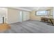 Large basement area featuring new carpet, two closets, and abundant natural light at 7492 W Cedar Cir, Lakewood, CO 80226