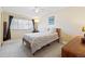 Bedroom with neutral carpet and window, decorated with lamps and artwork at 7492 W Cedar Cir, Lakewood, CO 80226