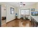 Cozy dining area features wood floors and natural light from a large window at 7492 W Cedar Cir, Lakewood, CO 80226