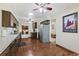 Well-lit kitchen featuring stainless steel appliances, dark wood cabinetry, and wood floors at 7492 W Cedar Cir, Lakewood, CO 80226