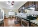 Spacious kitchen features stainless steel appliances and dark wood cabinetry at 7492 W Cedar Cir, Lakewood, CO 80226