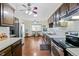 Spacious kitchen features stainless steel appliances and dark wood cabinetry at 7492 W Cedar Cir, Lakewood, CO 80226