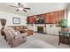 Living room features a wood panel accent wall and a classic fireplace at 7492 W Cedar Cir, Lakewood, CO 80226