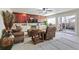 Living room features a wood panel accent wall, sliding glass door to the patio and comfortable seating at 7492 W Cedar Cir, Lakewood, CO 80226