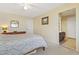 Bedroom features a dresser and doorway to an en-suite bathroom at 7492 W Cedar Cir, Lakewood, CO 80226