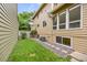Side yard of home featuring green lawn, stepping stones, and beige siding on the home at 76 Mineola Ct, Boulder, CO 80303