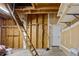 Unfinished basement with ladder, open walls, and shelving offers potential for customization at 76 Mineola Ct, Boulder, CO 80303