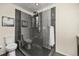Modern bathroom showcasing a sleek glass-enclosed shower with stylish tiling and fixtures, and a toilet at 76 Mineola Ct, Boulder, CO 80303