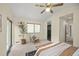 Bright bedroom featuring vaulted ceilings, a ceiling fan, a cozy chair near the window, and an ensuite bathroom at 76 Mineola Ct, Boulder, CO 80303