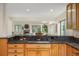 Gourmet kitchen featuring granite countertops, gas cooktop and an open layout to the living room and fireplace at 76 Mineola Ct, Boulder, CO 80303