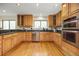 Spacious kitchen featuring stainless steel appliances, hardwood floors, and sleek granite countertops and backsplash at 76 Mineola Ct, Boulder, CO 80303
