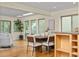 Sunlit living room and dining area with hardwood floors and many windows showcasing the natural exterior environment at 76 Mineola Ct, Boulder, CO 80303