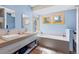 Bathroom featuring double vanity, soaking tub, and natural light from multiple windows at 293 Settlers Dr, Breckenridge, CO 80424