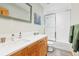 Bright bathroom features a wood vanity, white countertop, modern fixtures, and a shower with white tiles at 293 Settlers Dr, Breckenridge, CO 80424