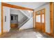 Inviting entryway with wooden accents, tiled floor, and a modern staircase with metal railings leading to the upper level at 293 Settlers Dr, Breckenridge, CO 80424