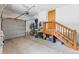 Spacious garage featuring a garage door, staircase, and storage for bikes and outdoor gear at 293 Settlers Dr, Breckenridge, CO 80424