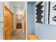 Hallway featuring wood-paneled doors, tile flooring, and a glimpse into a half bath with a wood vanity and round mirror at 293 Settlers Dr, Breckenridge, CO 80424