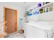 Functional laundry room with a washing machine, dryer, shelving, and a convenient ironing board at 293 Settlers Dr, Breckenridge, CO 80424