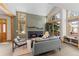Bright, open-concept living room features a modern fireplace, high ceilings, and floor to ceiling windows at 293 Settlers Dr, Breckenridge, CO 80424