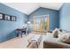Bright living room with desk, sofa, and a large window with picturesque mountain views at 293 Settlers Dr, Breckenridge, CO 80424