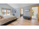 Bright main bedroom featuring hardwood floors, large windows, and access to an ensuite bathroom and hallway at 293 Settlers Dr, Breckenridge, CO 80424