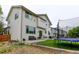 Back of the two story home, showing the back patio, level yard, and trampoline at 1995 E 166Th Ave, Thornton, CO 80602