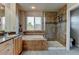Beautiful bathroom featuring a soaking tub, separate shower, and tile flooring at 1995 E 166Th Ave, Thornton, CO 80602