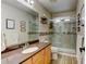 Well-lit bathroom features a single sink vanity, a modern glass shower, and tile flooring at 1995 E 166Th Ave, Thornton, CO 80602