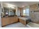 Elegant bathroom with double vanity, soaking tub, and a separate glass-enclosed shower at 1995 E 166Th Ave, Thornton, CO 80602