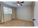 Simple bedroom with neutral carpeting, a ceiling fan, and lots of natural light from the window at 1995 E 166Th Ave, Thornton, CO 80602