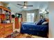Charming bedroom with vaulted ceilings, ceiling fan, dresser with television and lots of decorations at 1995 E 166Th Ave, Thornton, CO 80602