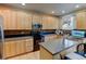 Bright kitchen with wooden cabinets, granite countertops, stainless appliances, and stylish backsplash at 1995 E 166Th Ave, Thornton, CO 80602