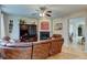 Living room with hardwood floors, cozy fireplace, and a comfortable leather sectional at 1995 E 166Th Ave, Thornton, CO 80602