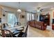 Open floor plan living room featuring hardwood floors and leather reclining sofa at 1995 E 166Th Ave, Thornton, CO 80602