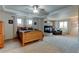 Spacious primary bedroom features tray ceilings, fireplace, sitting area, and large windows at 1995 E 166Th Ave, Thornton, CO 80602