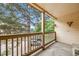 Private balcony overlooking a parking lot with trees at 14852 E Kentucky Dr # 928, Aurora, CO 80012