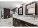 Modern bathroom featuring dual vanities, marble countertops, and stylish tiled shower and backsplash at 14852 E Kentucky Dr # 928, Aurora, CO 80012