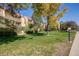 Apartment complex with grassy area and trees at 14852 E Kentucky Dr # 928, Aurora, CO 80012