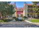 Inviting exterior view of a condo building with a red roof and well-maintained landscaping at 14852 E Kentucky Dr # 928, Aurora, CO 80012