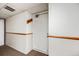 Neutral hallway featuring a door marked with 928, with white walls and brown trim at 14852 E Kentucky Dr # 928, Aurora, CO 80012