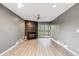 Cozy living area with hardwood floors, a modern ceiling fan, and a stylish stone fireplace at 14852 E Kentucky Dr # 928, Aurora, CO 80012