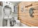 A half-bath with decorative wood paneling, a vessel sink, and a marine theme at 720 Reid Pl, Castle Rock, CO 80108
