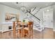 Dining room with a modern chandelier, an abstract art piece, and a staircase with black handrails at 720 Reid Pl, Castle Rock, CO 80108
