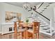 Elegant dining area with stylish chandelier, a round wooden table, and views of the staircase at 720 Reid Pl, Castle Rock, CO 80108
