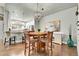 Open concept dining area with wood table, chandelier, and view of the kitchen at 720 Reid Pl, Castle Rock, CO 80108