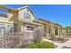 Townhome exterior showcasing stone detailing, a covered porch, and manicured landscaping at 720 Reid Pl, Castle Rock, CO 80108