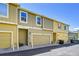 Townhome featuring a neutral exterior, attached garages, and well-maintained landscaping at 720 Reid Pl, Castle Rock, CO 80108