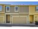 Street view of the townhome showcasing the neutral exterior and attached two-car garage at 720 Reid Pl, Castle Rock, CO 80108
