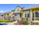 Inviting townhome with stone accents, a covered porch, and tidy front yard landscaping at 720 Reid Pl, Castle Rock, CO 80108